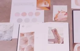 Flat lay mood board featuring color swatches, typography samples, and layout inspiration cards for website branding.