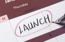 Calendar page with the word LAUNCH circled in pink pen representing a completed website going live.