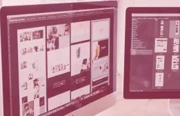 Desktop computer monitors displaying website wireframes, responsive UI page layouts, and active web development files.